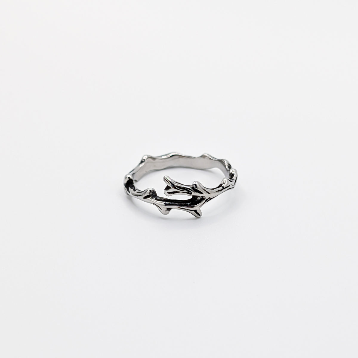 Alternative angle of a stainless steel ring with a design resembling antlers.