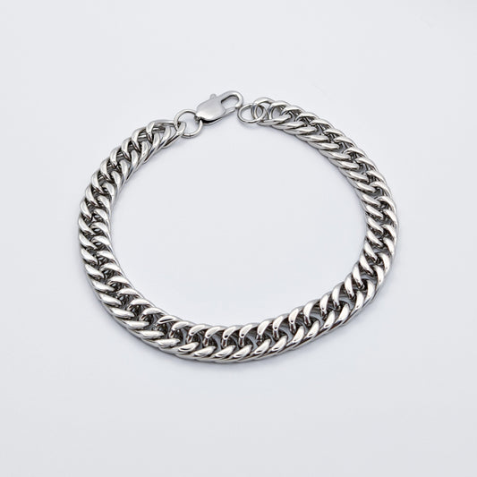 Polished Cuban link style chain link bracelet made from stainless steel featuring a lobster clasp.
