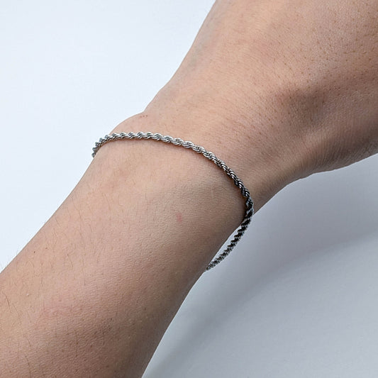 Close up of silver stainles steel bracelet on a wrist.