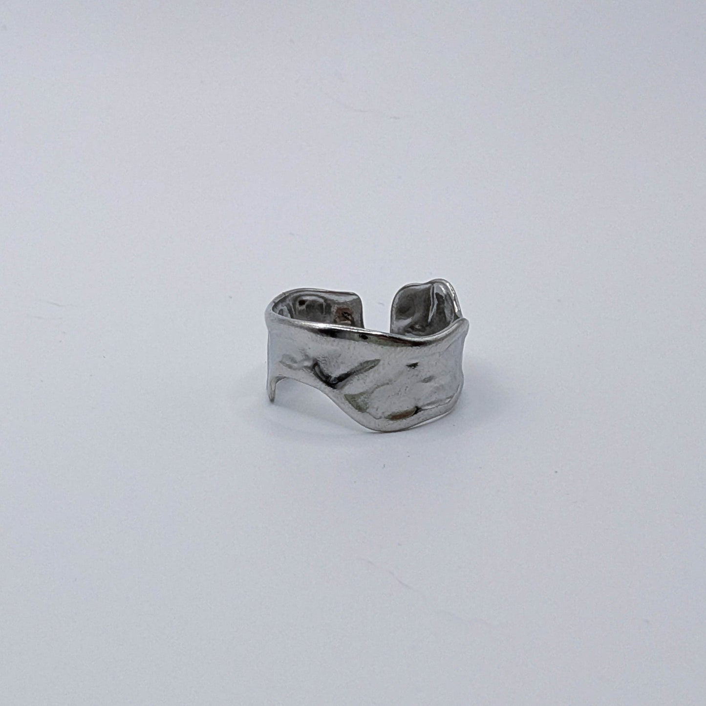 Modern stainless steel ring with organic design and open back in a different orientation.