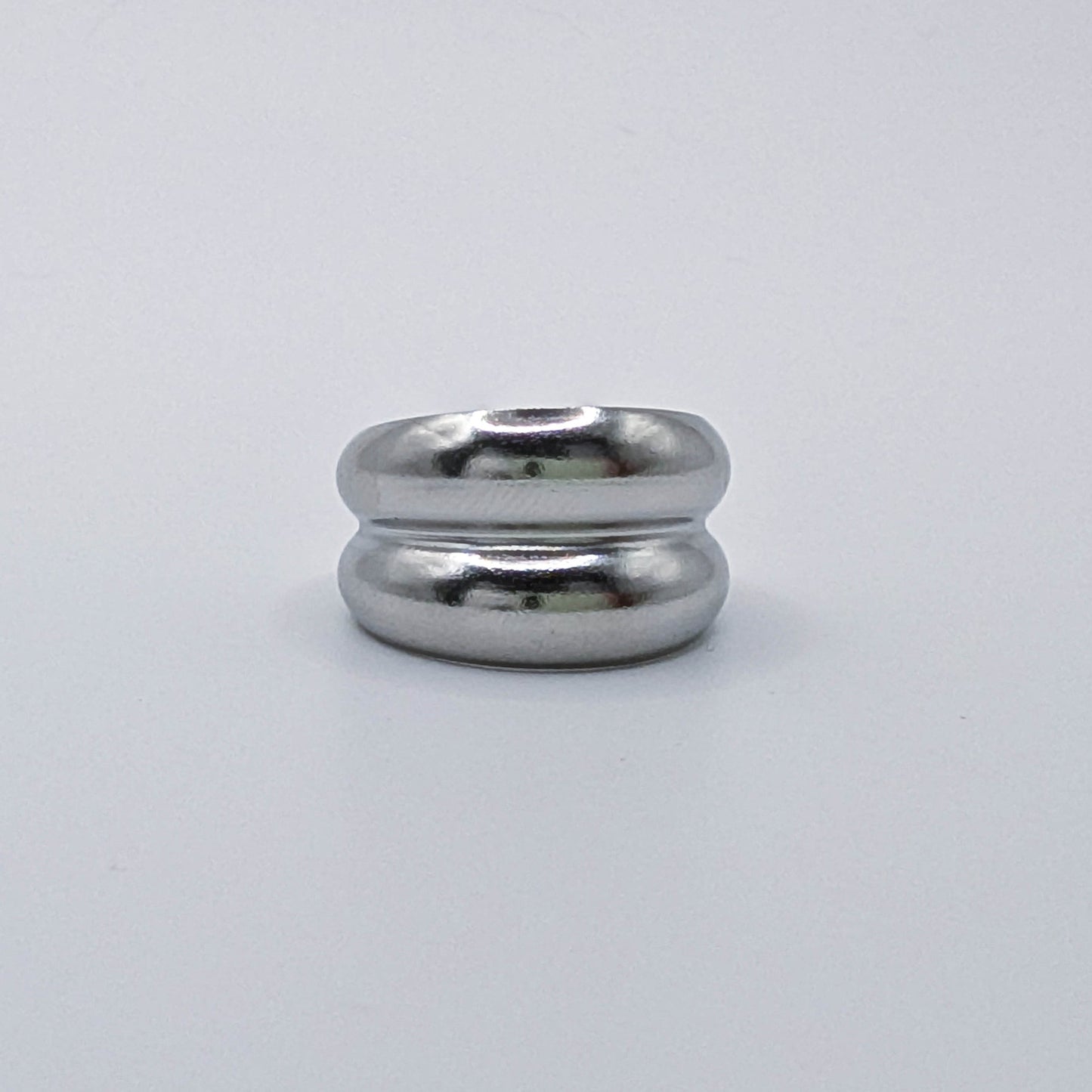 Close up shot of a silver layered stainless steel ring showcasing the parallel dual bands.