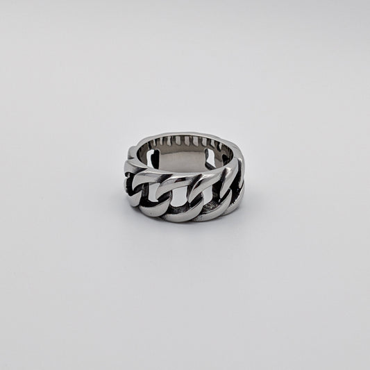 A stainless steel ring with a Cuban link design, displayed against a white background.