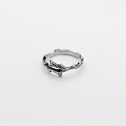 A stainless steel ring with a design resembling antlers.