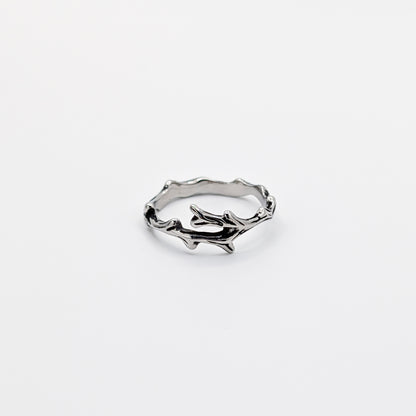 Alternative angle of a stainless steel ring with a design resembling antlers.