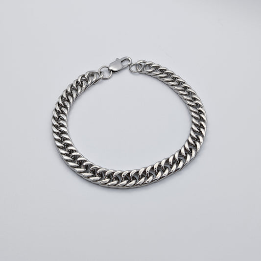 Polished Cuban link style bracelet made from stainless steel featuring a lobster clasp.