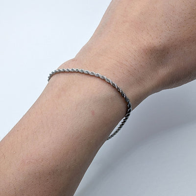 Close up of silver stainles steel bracelet on a wrist.