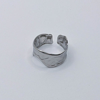 Modern stainless steel ring with organic design and open back.