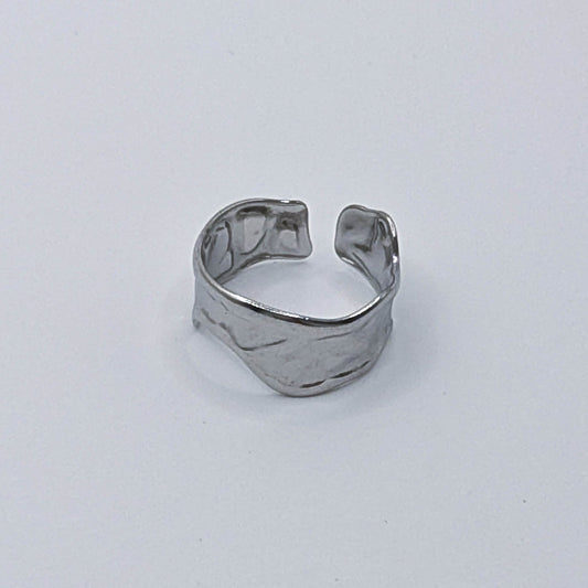 Modern stainless steel ring with organic design and open back.