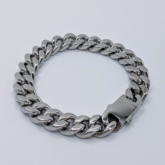 Polished heavy Cuban link bracelet made from stainless steel featuring a thick interlocking chain design on a white background.