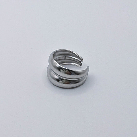 Polished minimalist stainless steel double wrap ring with a stacked open band design on a white background.