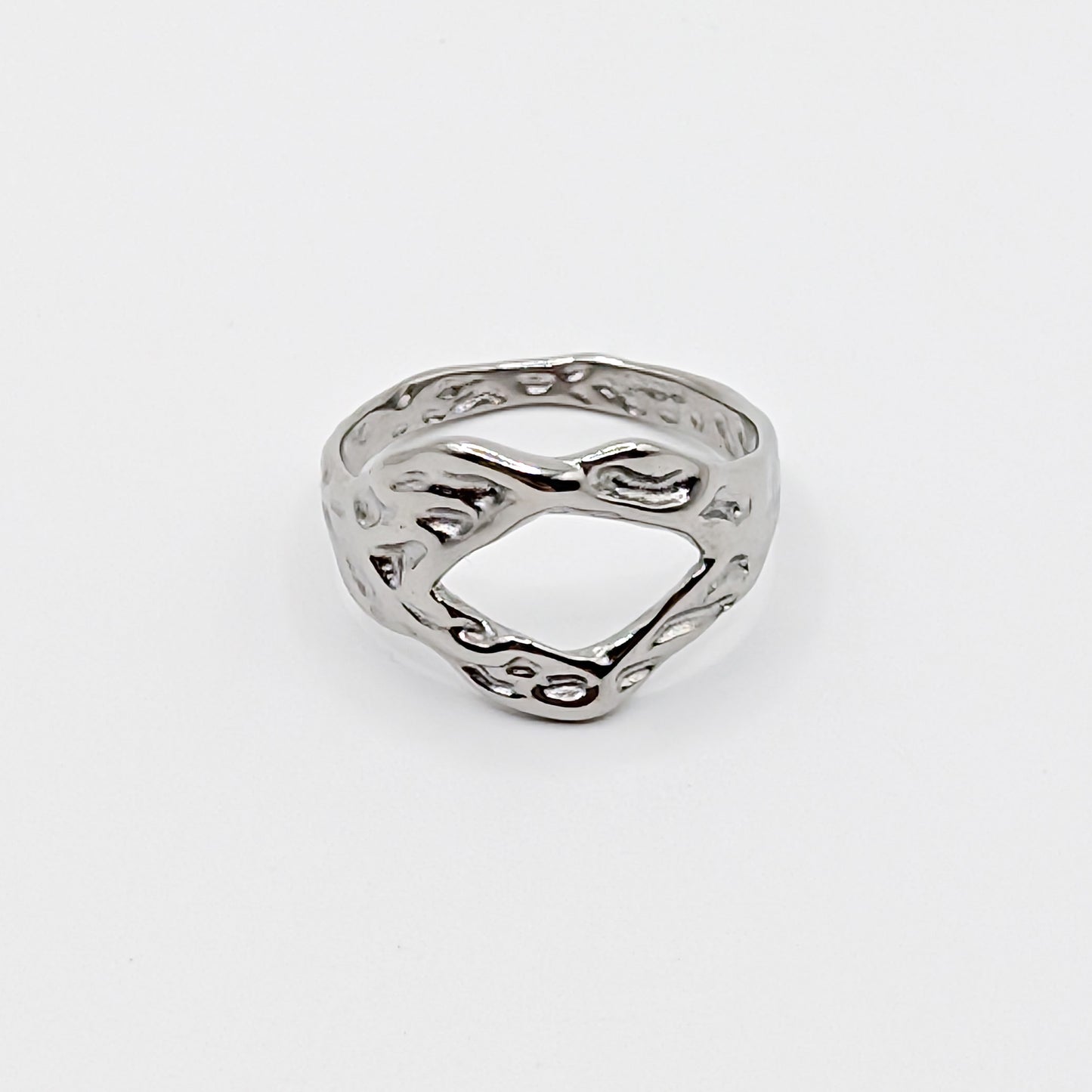 Textured stainless steel ring with an open cutouts on a white background.