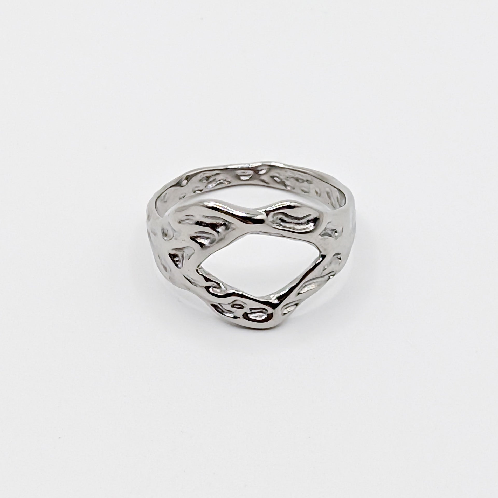 Textured stainless steel ring with an open cutouts on a white background.