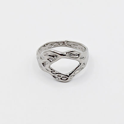 Textured stainless steel ring with an open cutouts on a white background.