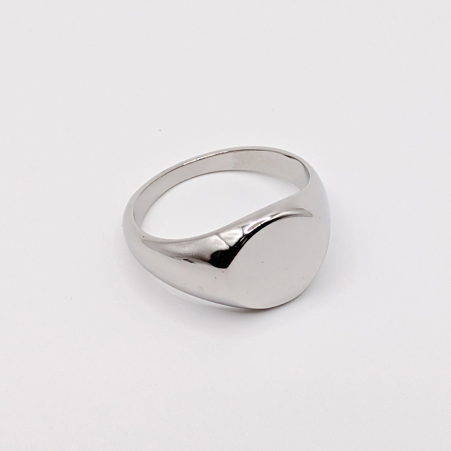 Angled detail shot of a silver steel signet ring.
