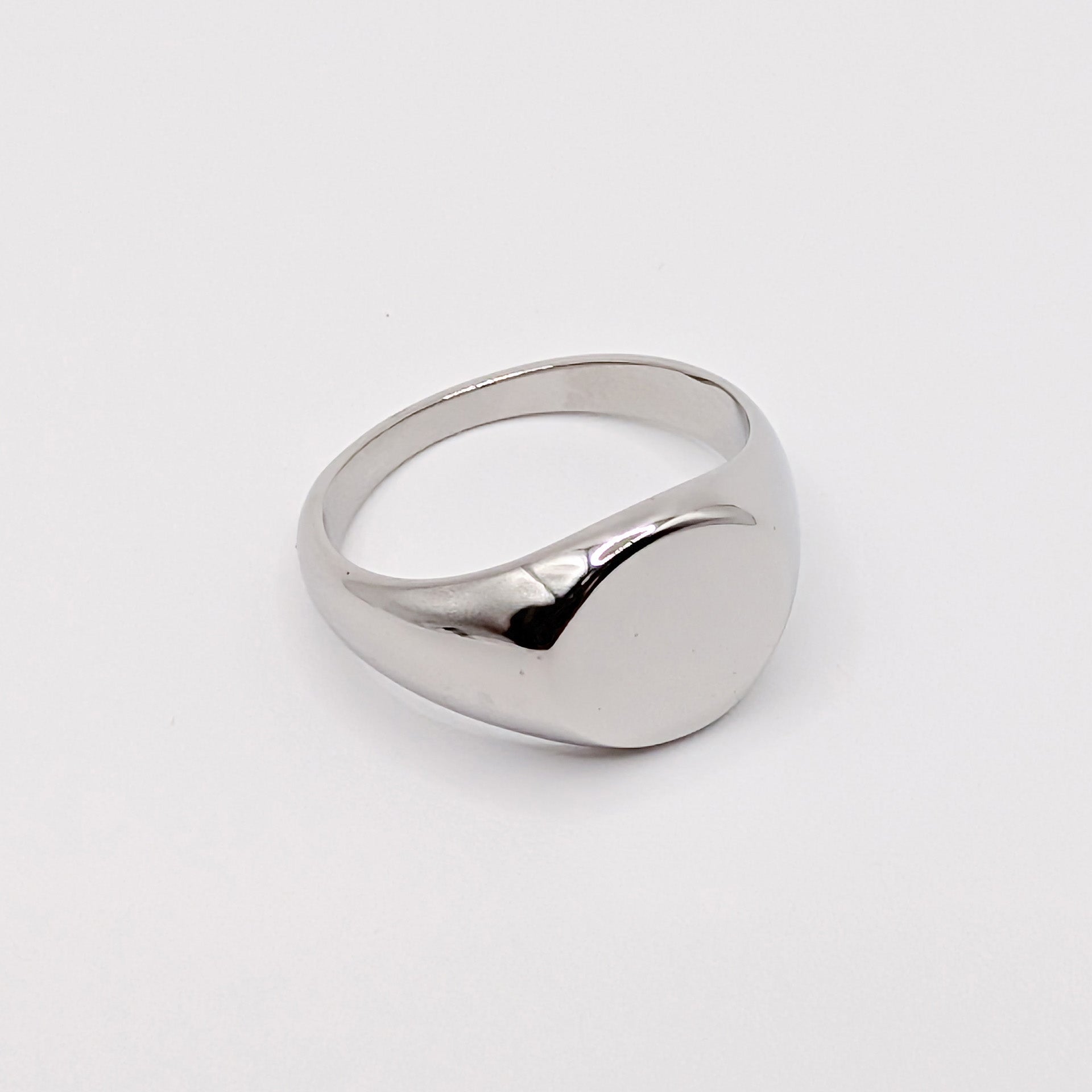 Angled detail shot of a silver steel signet ring.