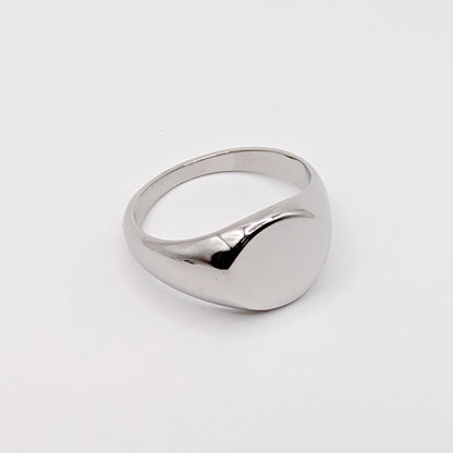 Angled detail shot of a silver steel signet ring.