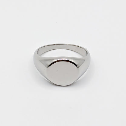 Minimalist polished stainless steel oval signet ring with a smooth blank face on a white background.