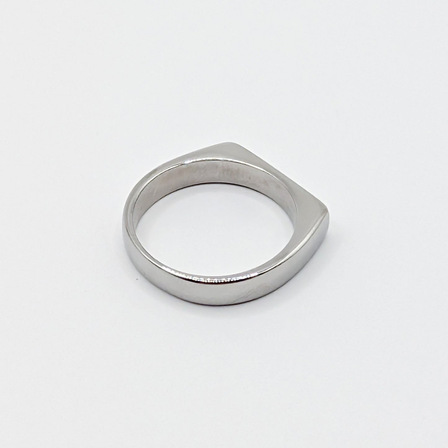 Alternative view of a heavy silver stainless steel band showing the smooth interior and flat edge profile.