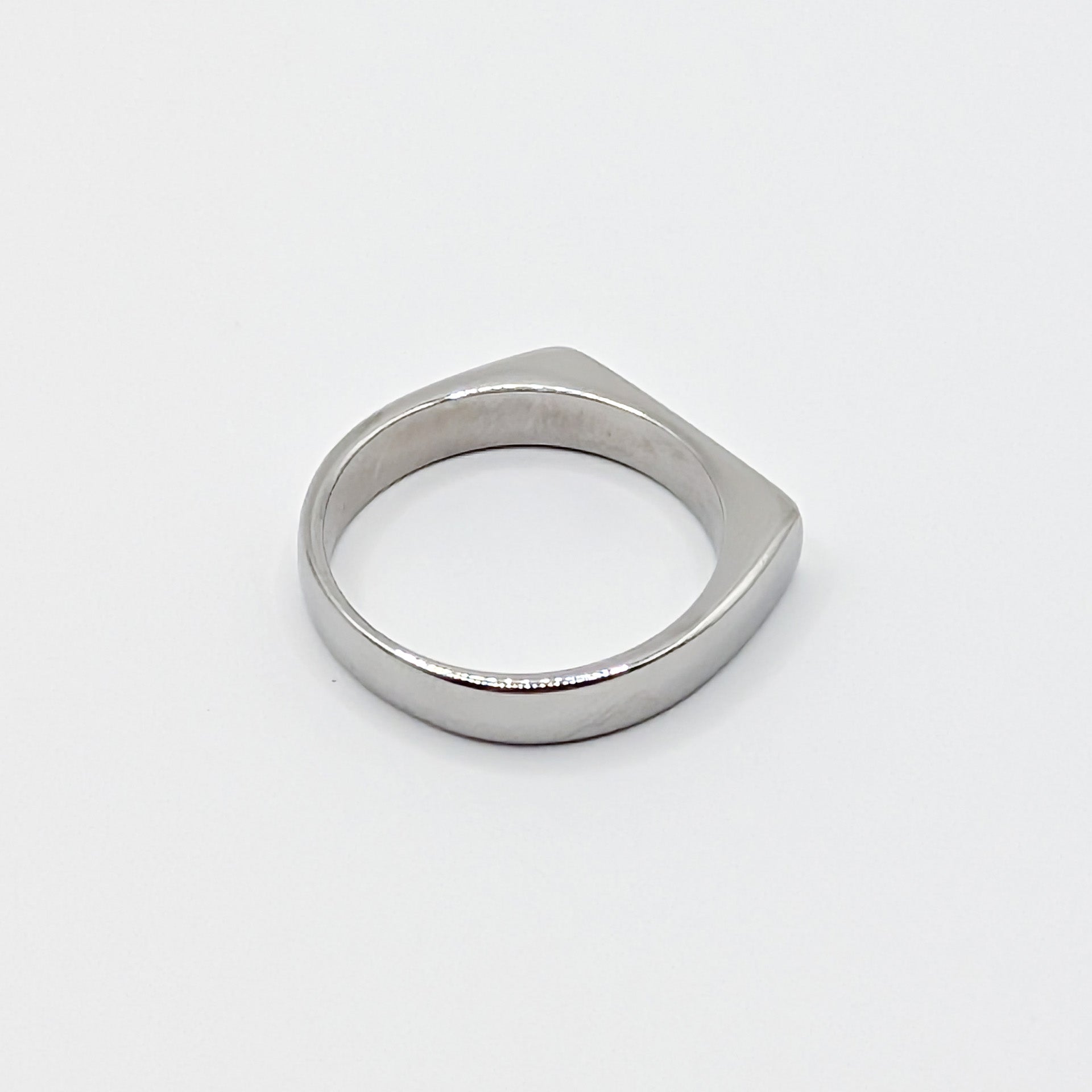 Alternative view of a heavy silver stainless steel band showing the smooth interior and flat edge profile.
