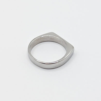 Alternative view of a heavy silver stainless steel band showing the smooth interior and flat edge profile.