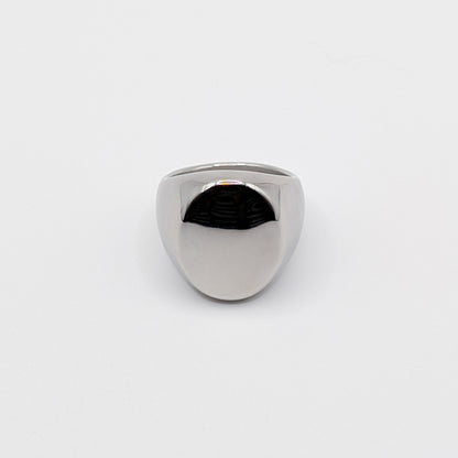 Thick polished minimalist stainless steel signet ring on a white background.
