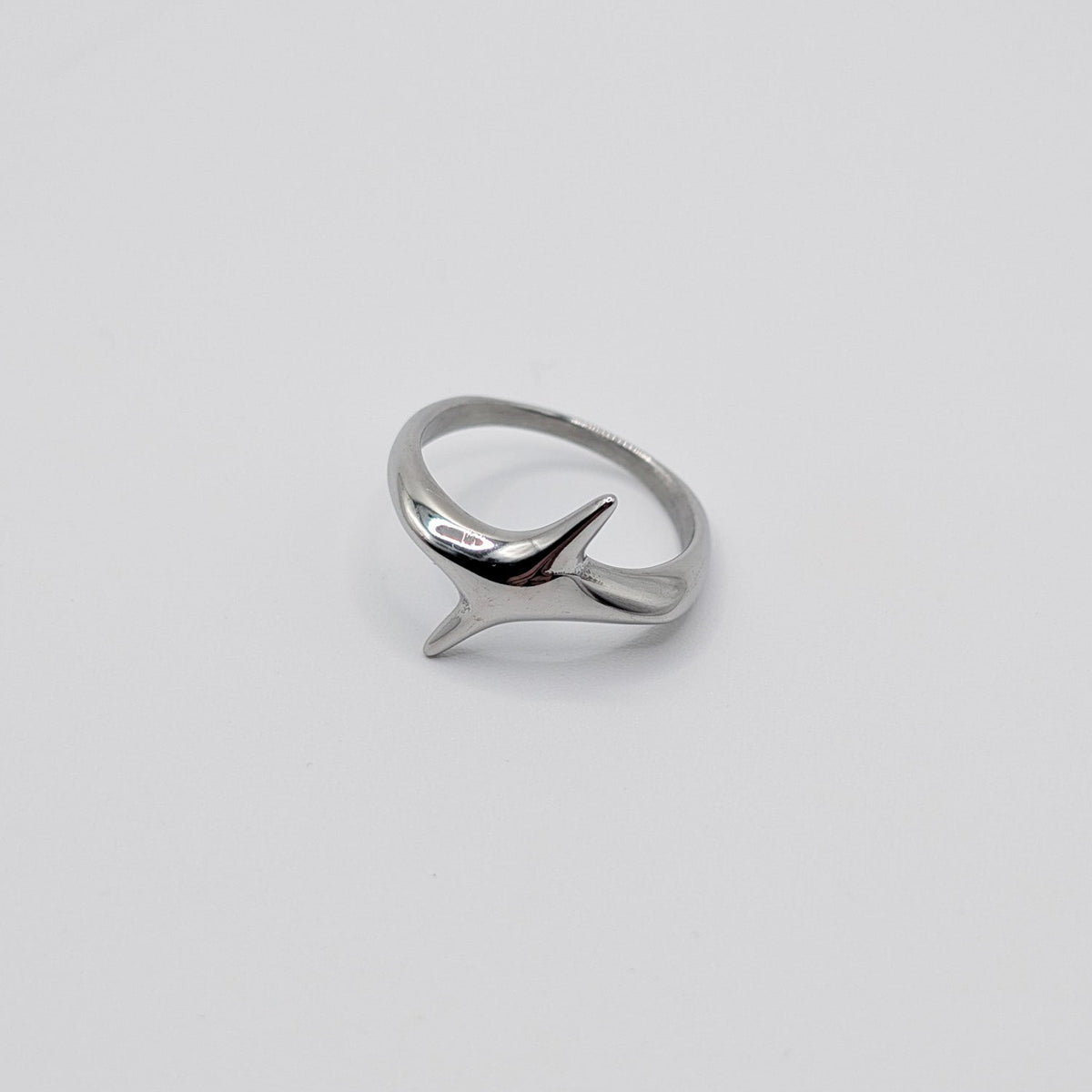 A polished stainless steel ring in the shape of star.