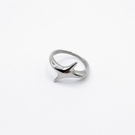 A silver polished stainless steel ring in the shape of 4 point star.